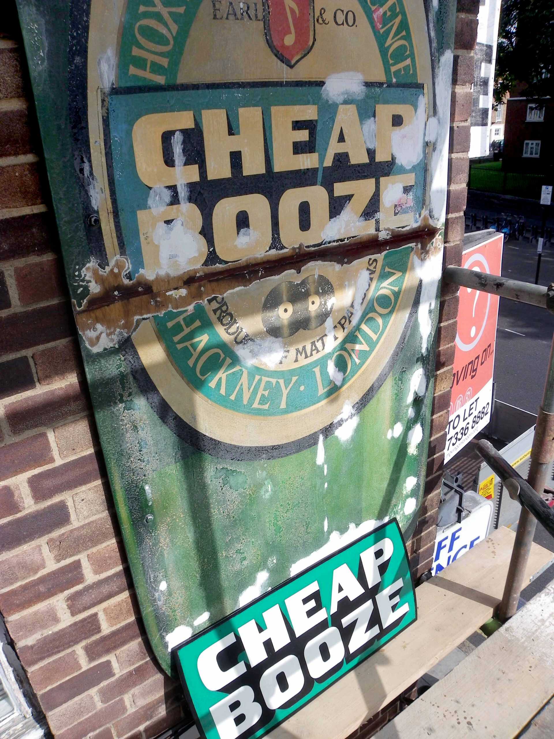 Repair work underway with replacement Cheap Booze sign to protect join in
panels.